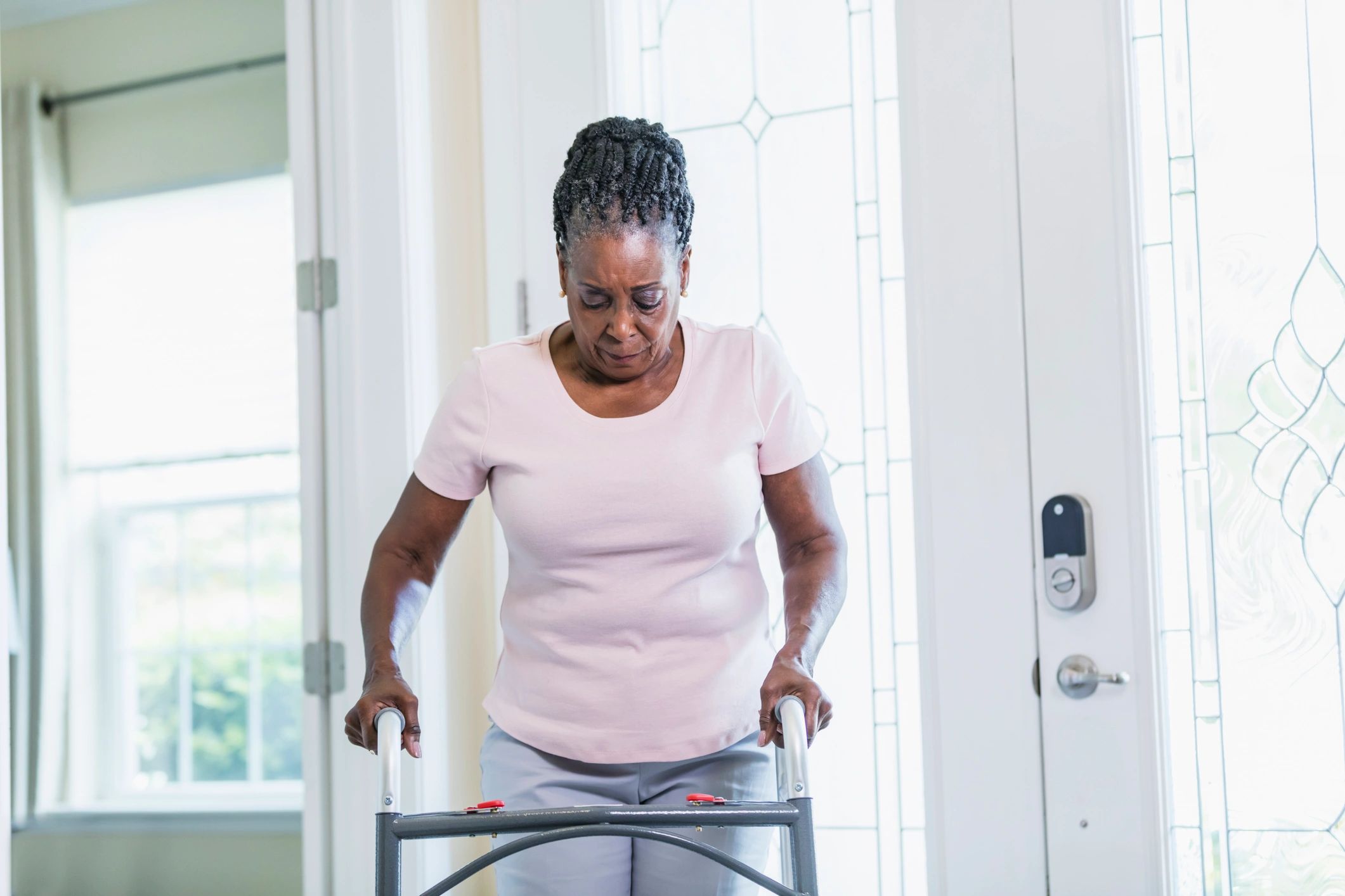 Senior woman using a walker at home