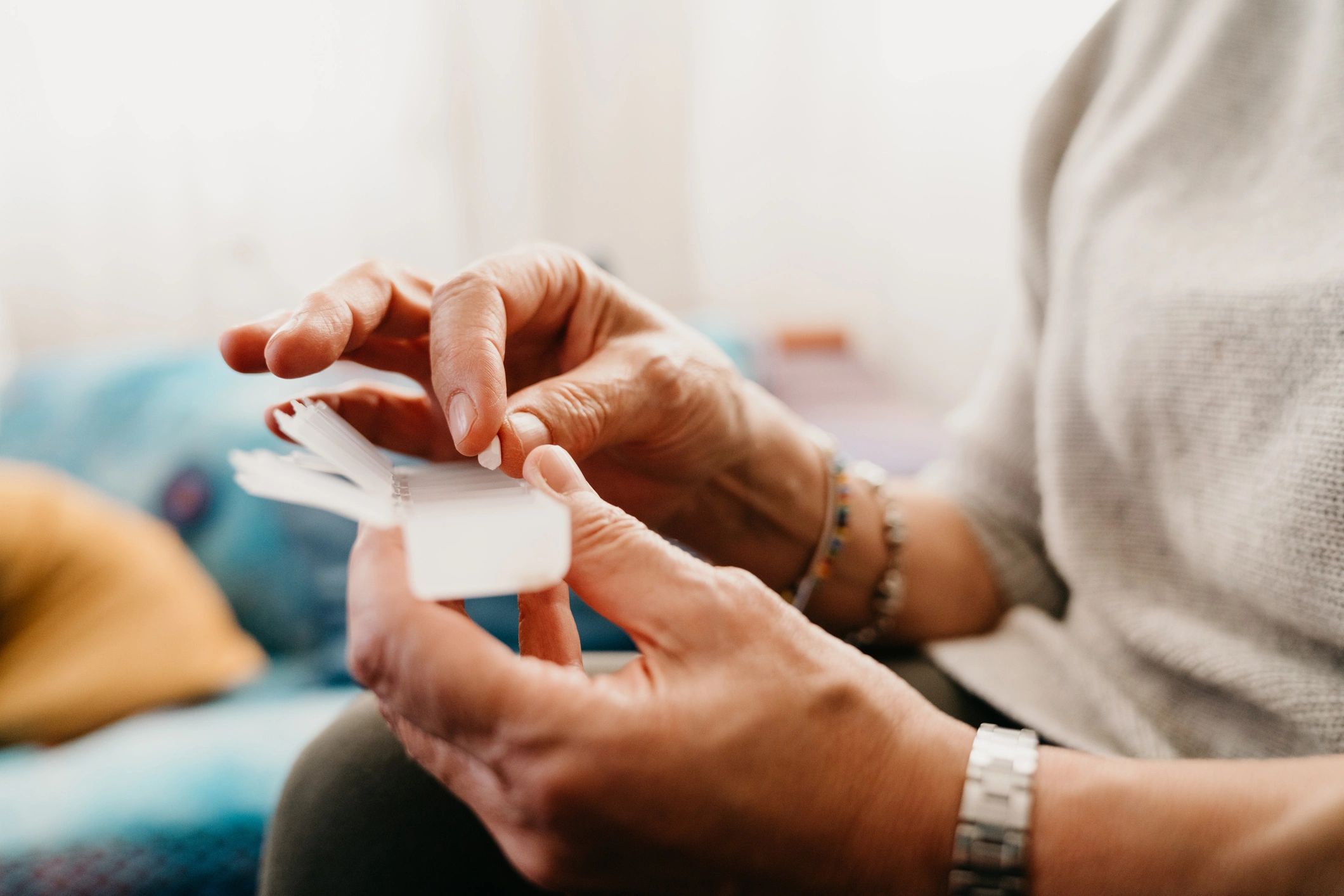 Caregiver organizing medications in a pill organizer