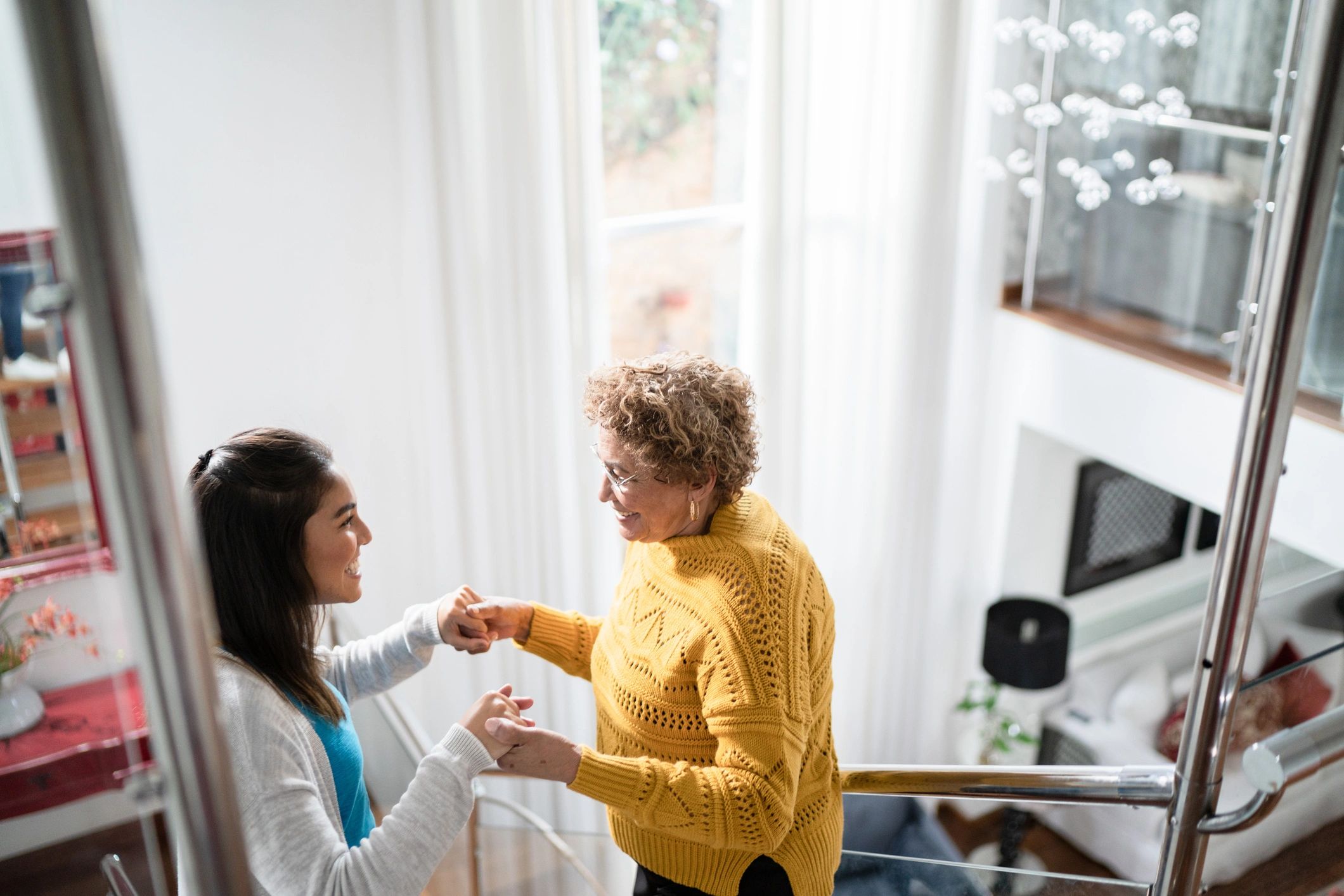 Caregiver supporting a senior during safe movement at home