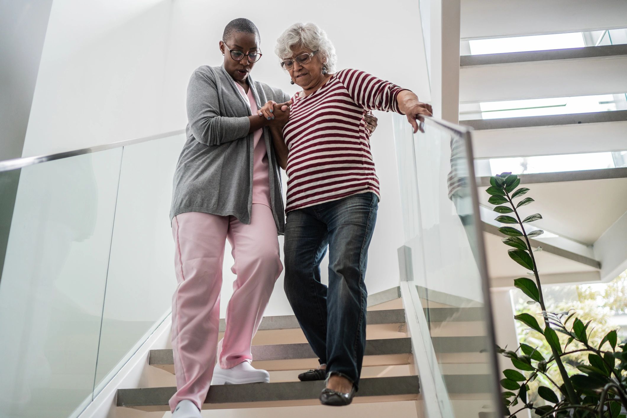 Caregiver helping a senior woman walk safely