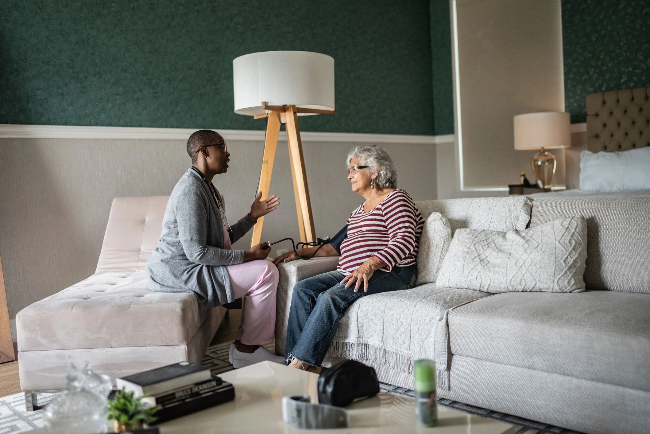 Clinician measuring a senior woman's blood pressure