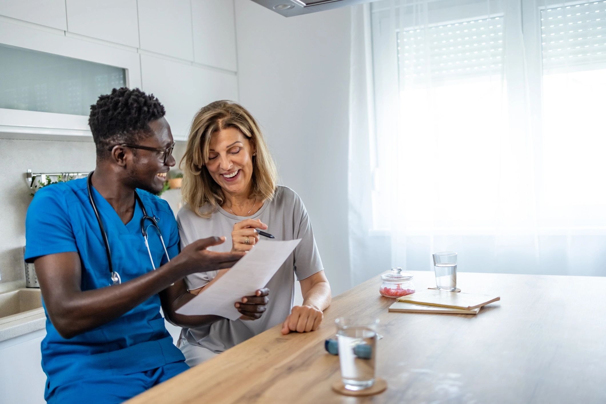 Nurse discussing product options with a senior woman at home