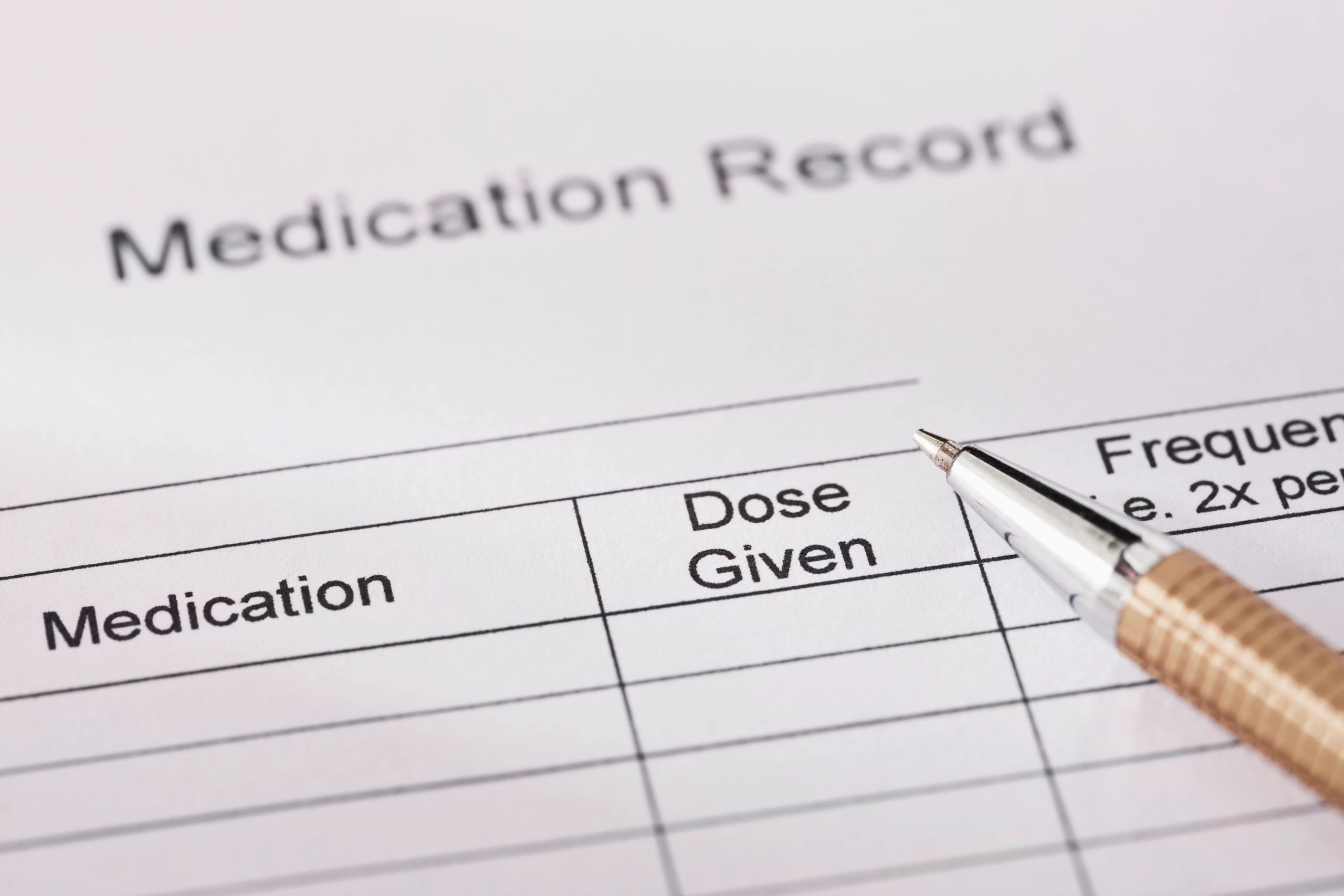Medication record form on a clipboard
