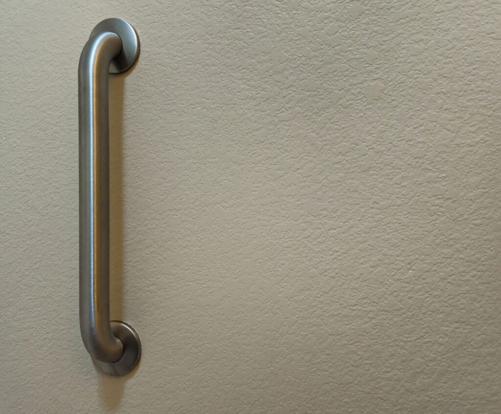 Bathroom grab bar installed on a wall for support and stability