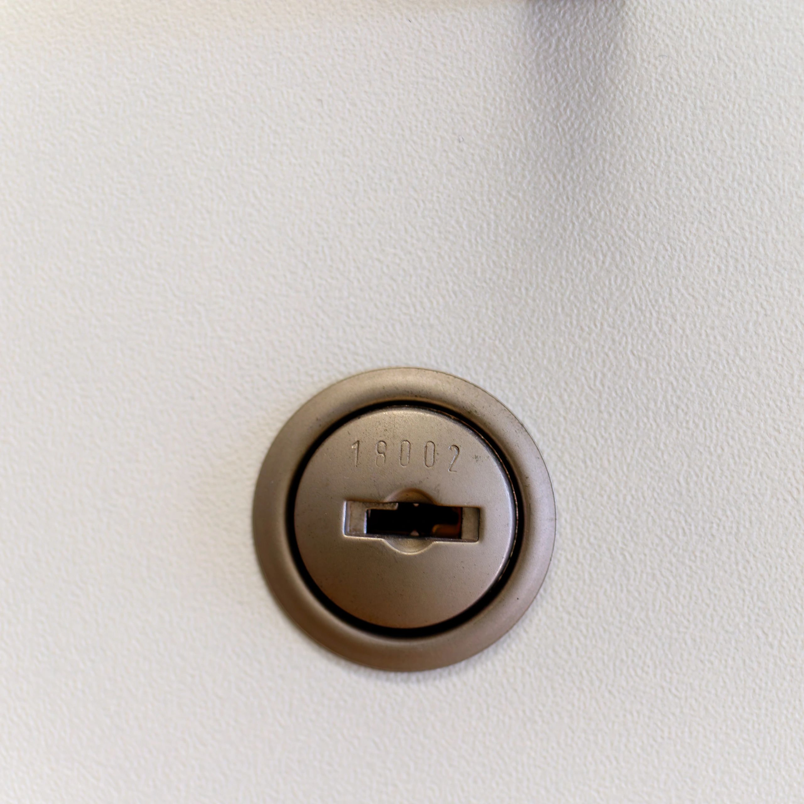 Close-up of a lock on a white surface
