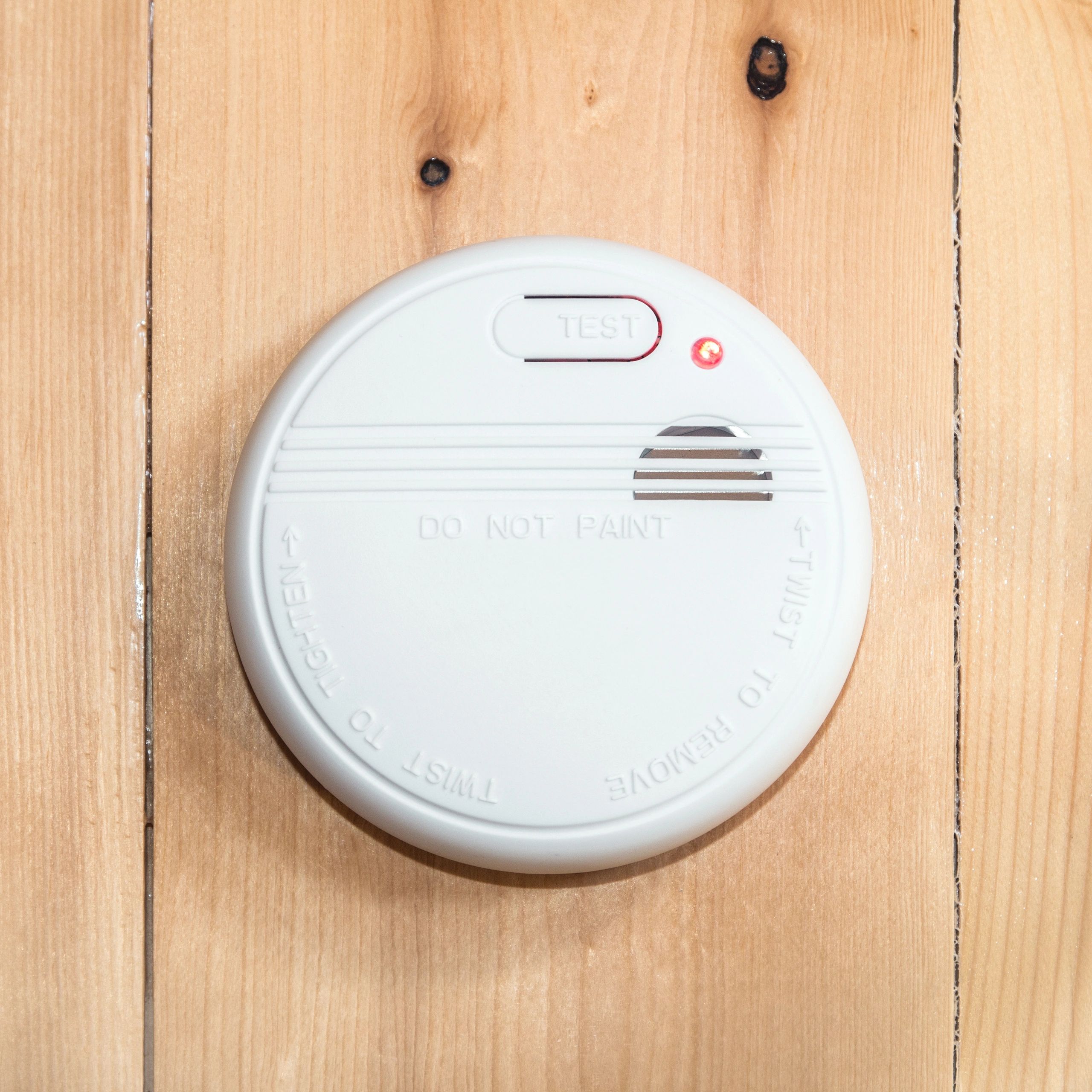 Wood ceiling mounted common white home smoke detector alarm square