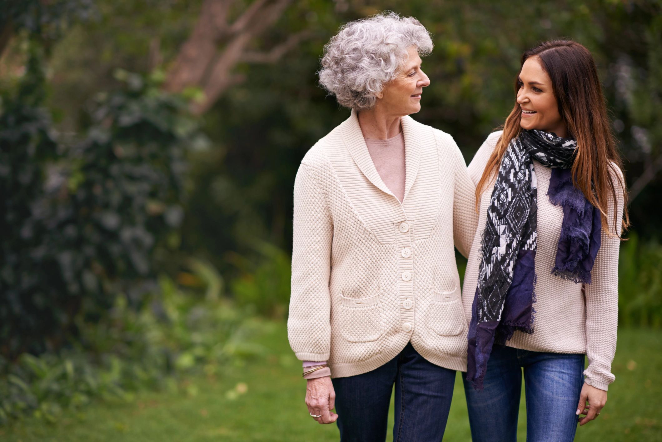 Adult daughter spending time with her senior mother outdoors